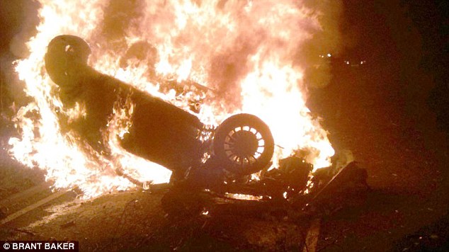 That was close! Off-duty firefighter snatches trapped driver from overturned car seconds before it erupts in fireball